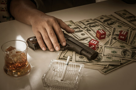 gun on table of money and drugs