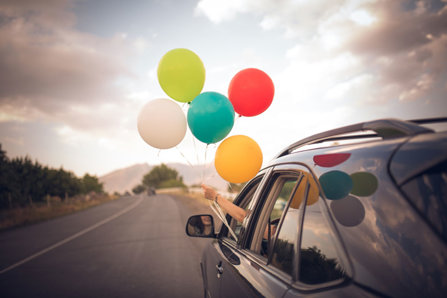 Balloons out of the window of a car