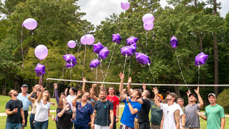 Narconon Louisiana - many people releasing purple balloons into a sky.