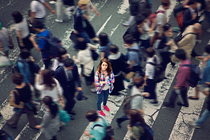 Woman surrounded by people
